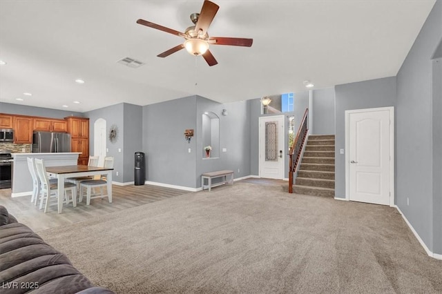 10845 Drake Ridge Ave, Las Vegas, NV 89166 - living room with ceiling fan, stairs, baseboards, light colored carpet, and recessed lighting