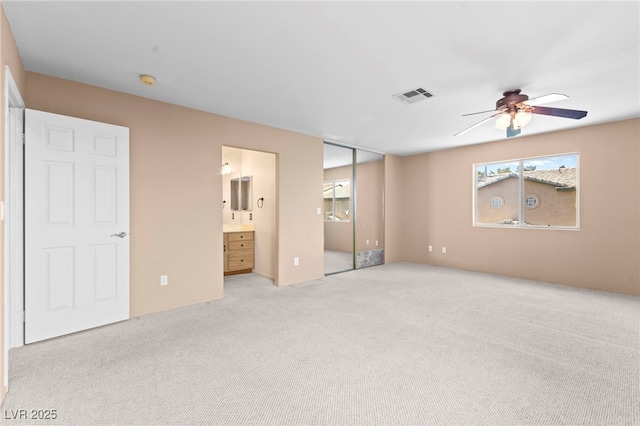 5615 Calais Ct, Las Vegas, NV 89118 - unfurnished bedroom featuring multiple windows, light colored carpet, and ensuite bath