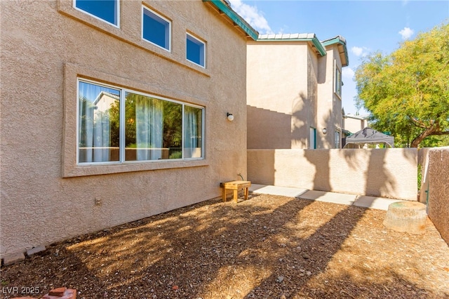 5615 Calais Ct, Las Vegas, NV 89118 - view of property exterior featuring stucco siding, a standing seam roof, and metal roof