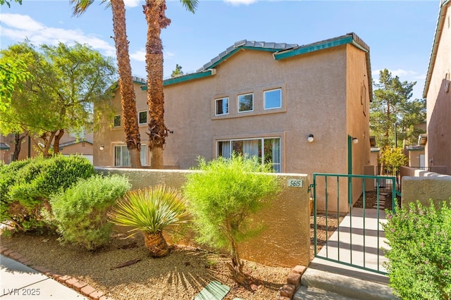 5615 Calais Ct, Las Vegas, NV 89118 - view of front of house with stucco siding and a gate