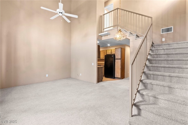 5615 Calais Ct, Las Vegas, NV 89118 - stairs featuring a high ceiling, carpet floors, and ceiling fan