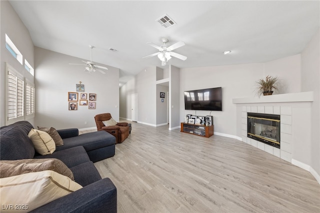 8316 Joseph Cary Ct, Las Vegas, NV 89145 - living area featuring ceiling fan, lofted ceiling, a fireplace, wood finished floors, and baseboards