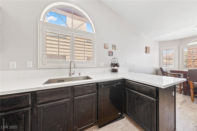 8316 Joseph Cary Ct, Las Vegas, NV 89145 - kitchen featuring black dishwasher, a sink, vaulted ceiling, plenty of natural light, and a peninsula