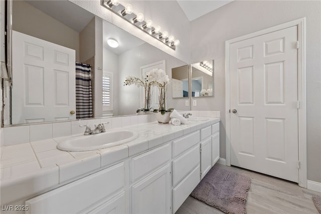 8316 Joseph Cary Ct, Las Vegas, NV 89145 - full bathroom with wood finished floors, double vanity, and baseboards