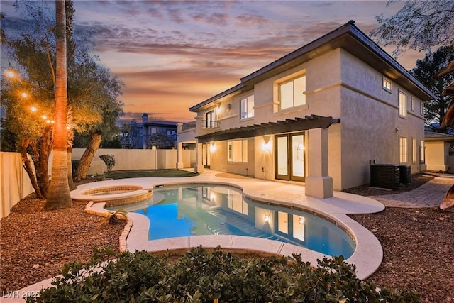 516 Pinnacle Heights Ln, Las Vegas, NV 89144 - back of house at dusk with a fenced backyard, a patio area, and stucco siding