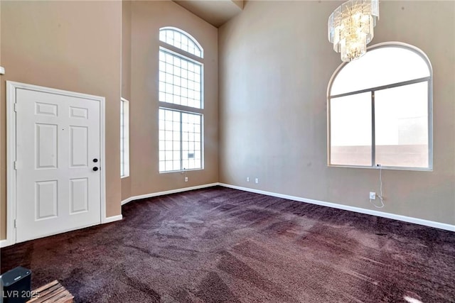 5341 Cool Dawn Ct, Las Vegas, NV 89130 - foyer entrance featuring dark carpet, a chandelier, baseboards, and a towering ceiling