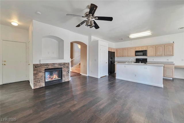 5341 Cool Dawn Ct, Las Vegas, NV 89130 - kitchen featuring black appliances, light brown cabinetry, open floor plan, ceiling fan, and a fireplace