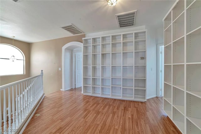 5341 Cool Dawn Ct, Las Vegas, NV 89130 - empty room with arched walkways and wood finished floors