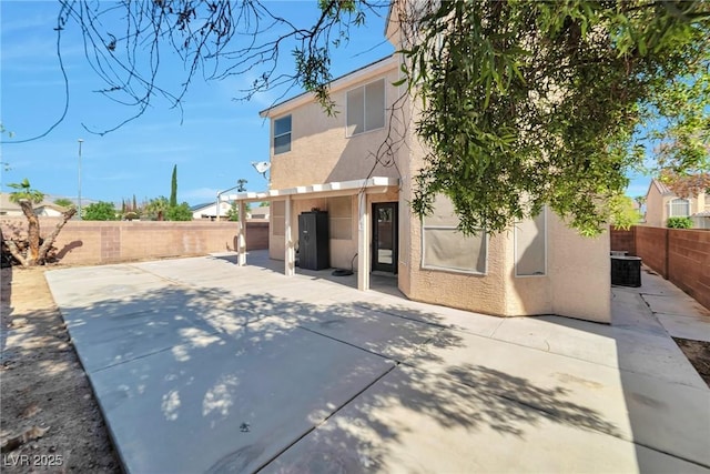 5341 Cool Dawn Ct, Las Vegas, NV 89130 - rear view of property featuring stucco siding, a patio area, a fenced backyard, and central air condition unit