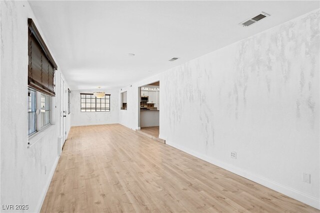 1655 E Hacienda Ave, Las Vegas, NV 89119 - unfurnished living room featuring light wood-style flooring and baseboards