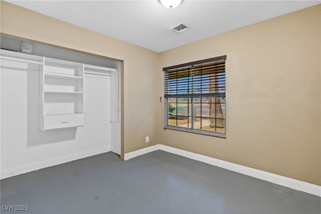 1655 E Hacienda Ave, Las Vegas, NV 89119 - unfurnished bedroom with finished concrete flooring, baseboards, and a closet