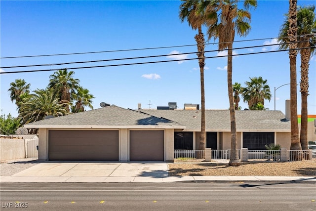 1655 E Hacienda Ave, Las Vegas, NV 89119 - ranch-style house featuring a garage, concrete driveway, stucco siding, and a shingled roof