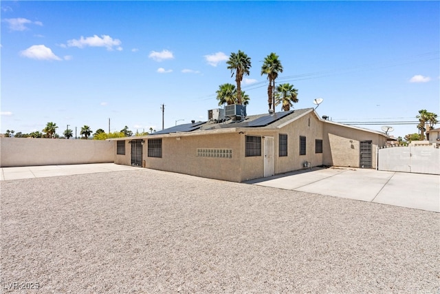 1655 E Hacienda Ave, Las Vegas, NV 89119 - rear view of house with a patio area, a fenced backyard, solar panels, and central air condition unit