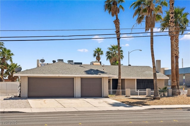 1655 E Hacienda Ave, Las Vegas, NV 89119 - ranch-style home with a garage, driveway, stucco siding, and roof with shingles