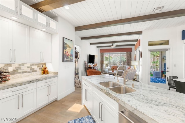 10404 Long Leaf Pl, Las Vegas, NV 89134 - kitchen with a sink, light wood-style flooring, backsplash, white cabinetry, and wooden ceiling with exposed beams