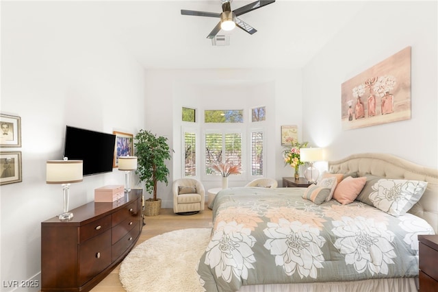 10404 Long Leaf Pl, Las Vegas, NV 89134 - bedroom with light wood-style floors, ceiling fan, and a towering ceiling