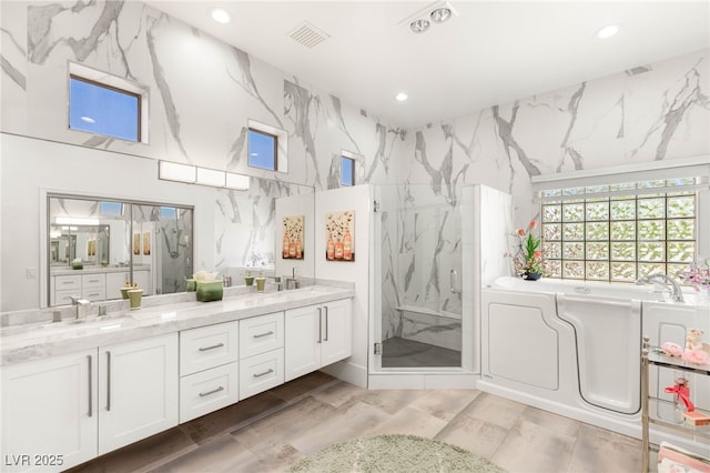 10404 Long Leaf Pl, Las Vegas, NV 89134 - full bath with a marble finish shower, recessed lighting, double vanity, a bath, and wood finished floors