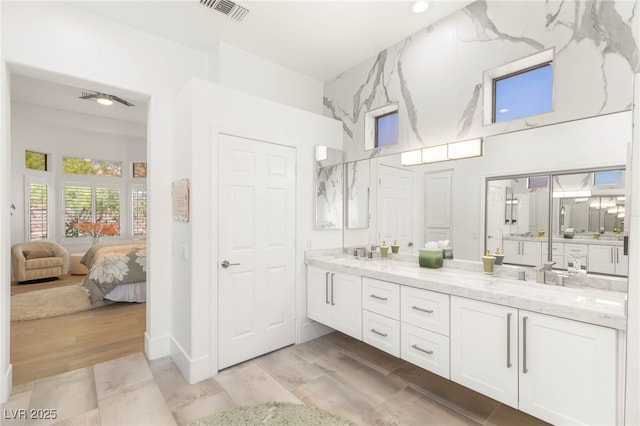10404 Long Leaf Pl, Las Vegas, NV 89134 - bathroom featuring double vanity, ensuite bathroom, a towering ceiling, wood finished floors, and a ceiling fan