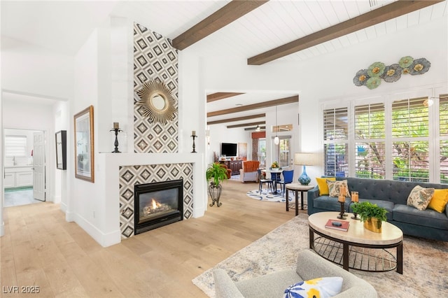 10404 Long Leaf Pl, Las Vegas, NV 89134 - living room featuring wood finished floors, beam ceiling, and a tile fireplace