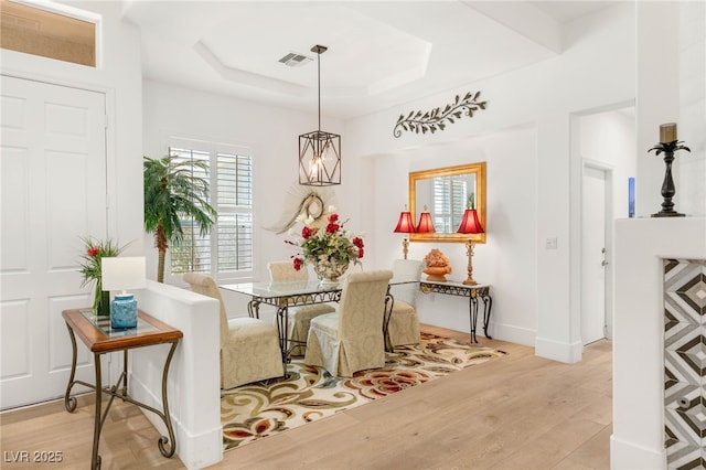 10404 Long Leaf Pl, Las Vegas, NV 89134 - dining area featuring light wood-style flooring, a raised ceiling, and baseboards