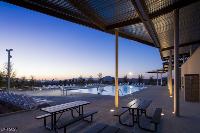 338 Taylor St, Henderson, NV 89015 - pool at dusk featuring a community pool and a patio area