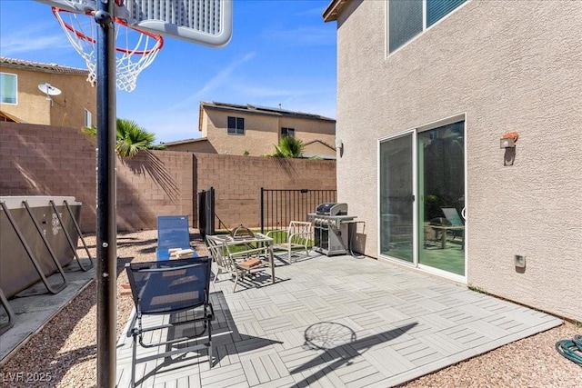 6857 Stone Tower Ct, Las Vegas, NV 89149 - fenced backyard featuring grilling area, a patio area, and a fire pit