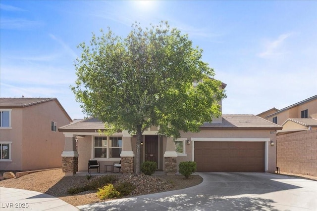6857 Stone Tower Ct, Las Vegas, NV 89149 - view of property hidden behind natural elements featuring concrete driveway, stone siding, an attached garage, and a tile roof