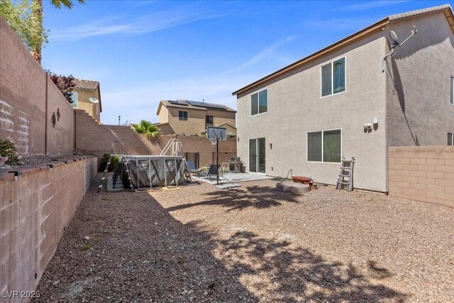 6857 Stone Tower Ct, Las Vegas, NV 89149 - back of house featuring a patio, a fenced backyard, and stucco siding