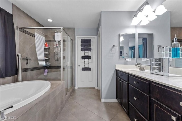 6857 Stone Tower Ct, Las Vegas, NV 89149 - bathroom with tile patterned floors, a bath, a stall shower, vanity, and baseboards