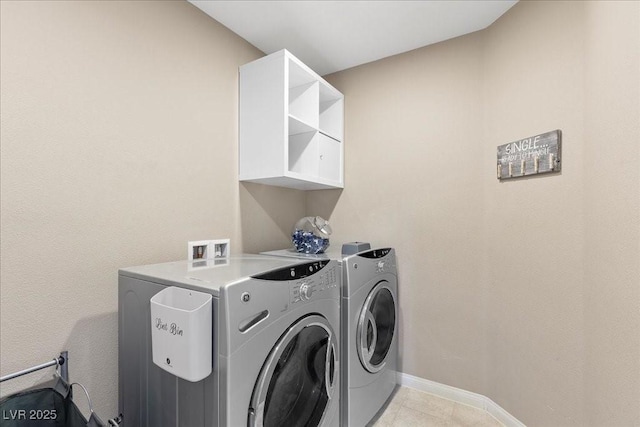 6857 Stone Tower Ct, Las Vegas, NV 89149 - laundry room with independent washer and dryer, light tile patterned flooring, and baseboards