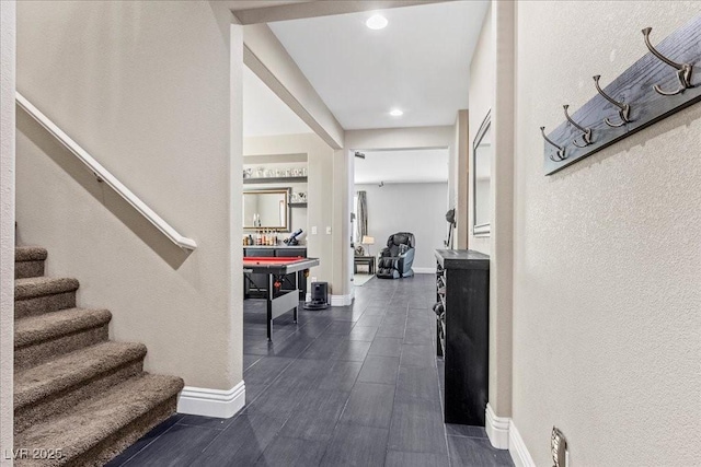 6857 Stone Tower Ct, Las Vegas, NV 89149 - corridor with stairway, a textured wall, baseboards, recessed lighting, and dark wood-style flooring