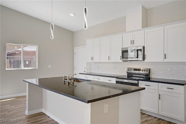 2130 Revere St, North Las Vegas, NV 89030 - kitchen with stainless steel appliances, dark countertops, and backsplash