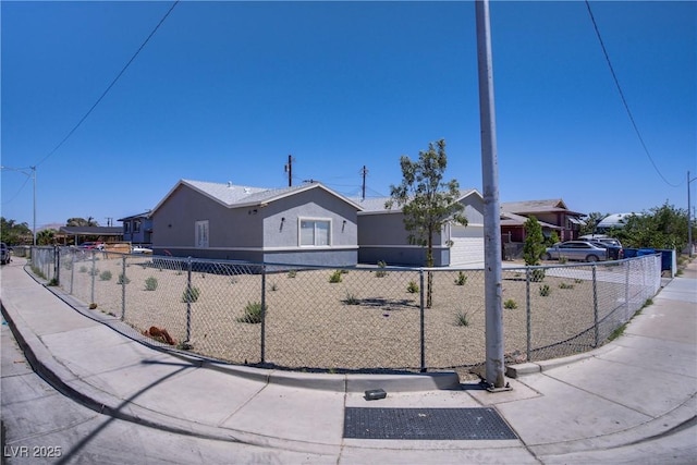 2130 Revere St, North Las Vegas, NV 89030 - view of front of house with a fenced front yard, concrete driveway, and stucco siding