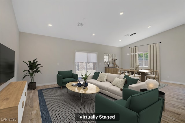 2130 Revere St, North Las Vegas, NV 89030 - living room featuring light wood finished floors, vaulted ceiling, and recessed lighting