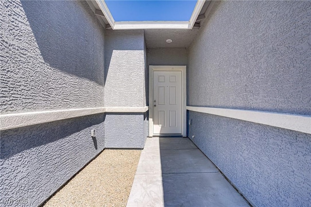 2130 Revere St, North Las Vegas, NV 89030 - view of exterior entry featuring stucco siding and a balcony