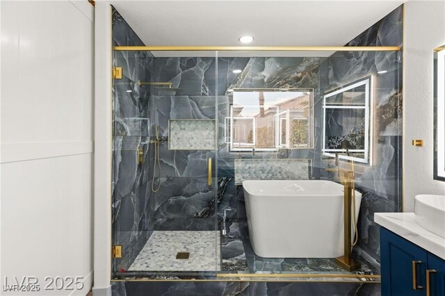 1613 Shadow Rock Dr, Las Vegas, NV 89117 - full bath featuring a freestanding bath, vanity, a marble finish shower, marble finish flooring, and tile walls