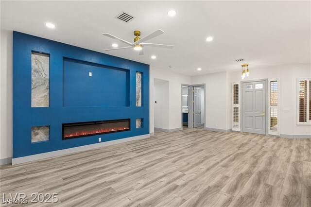 1613 Shadow Rock Dr, Las Vegas, NV 89117 - unfurnished living room featuring wood finished floors, ceiling fan, recessed lighting, baseboards, and a large fireplace