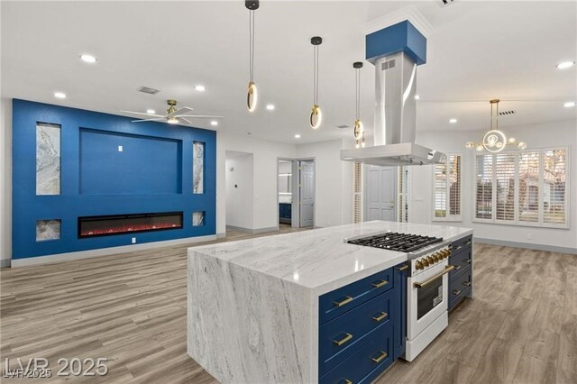 1613 Shadow Rock Dr, Las Vegas, NV 89117 - kitchen with high end white range oven, open floor plan, light wood-type flooring, a fireplace, and recessed lighting