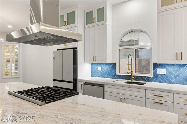 1613 Shadow Rock Dr, Las Vegas, NV 89117 - kitchen with island range hood, cooktop, freestanding refrigerator, a sink, and decorative backsplash