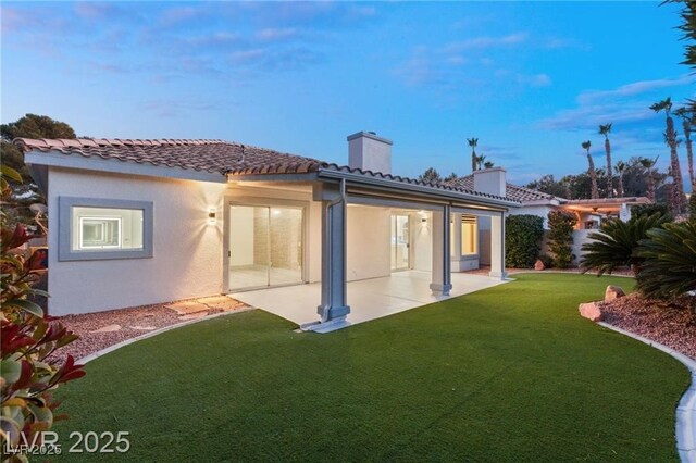 1613 Shadow Rock Dr, Las Vegas, NV 89117 - back of property featuring a chimney, a patio, stucco siding, and a yard