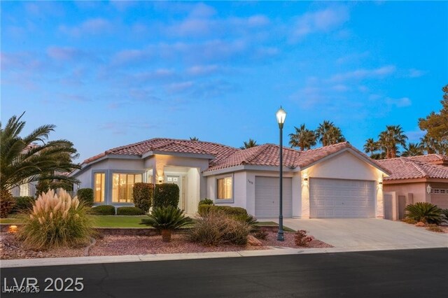 1613 Shadow Rock Dr, Las Vegas, NV 89117 - mediterranean / spanish-style home with an attached garage, a tile roof, concrete driveway, and stucco siding