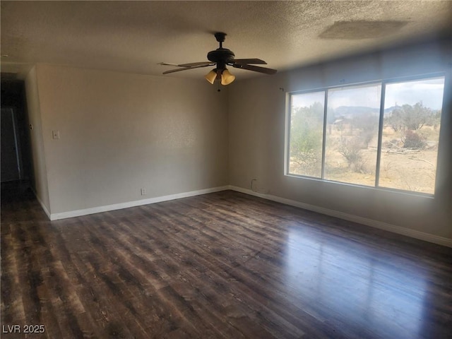 781 Buol Rd, Pahrump, NV 89048 - spare room featuring dark wood-style floors, a ceiling fan, baseboards, and a textured ceiling