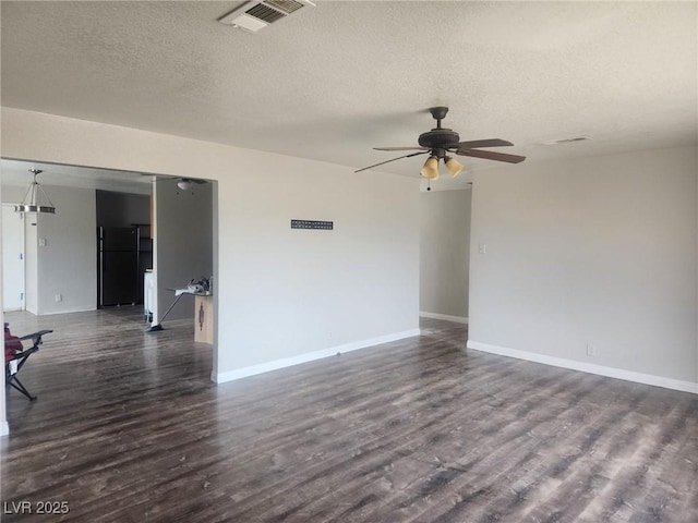 781 Buol Rd, Pahrump, NV 89048 - empty room with ceiling fan, dark wood-type flooring, a textured ceiling, and baseboards