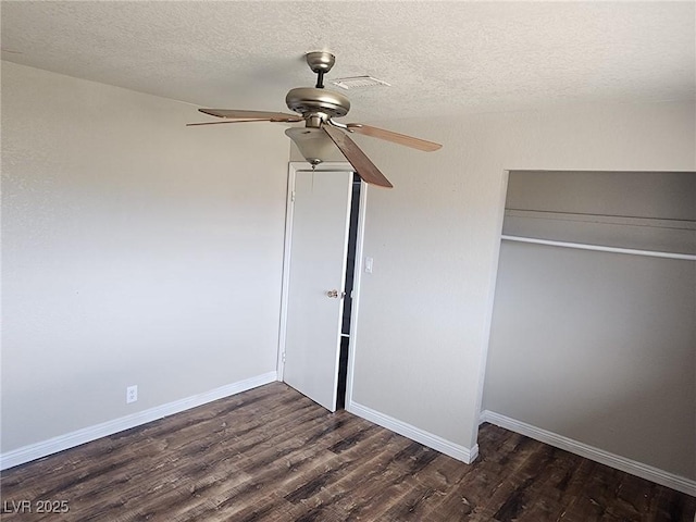 781 Buol Rd, Pahrump, NV 89048 - unfurnished bedroom with dark wood-style floors, a closet, a textured ceiling, baseboards, and ceiling fan