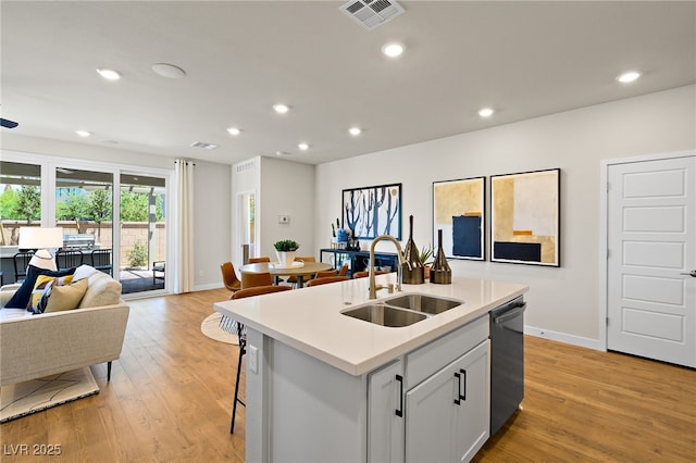 4180 E Brusca Way, Pahrump, NV 89061 - kitchen featuring open floor plan, a sink, baseboards, dishwashing machine, and light wood-style floors