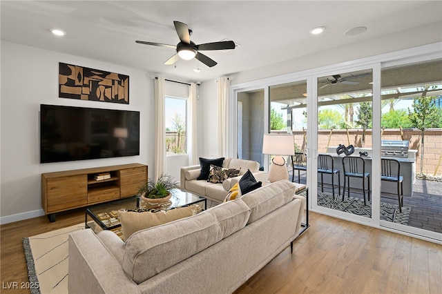 4180 E Brusca Way, Pahrump, NV 89061 - living room with ceiling fan, healthy amount of natural light, wood finished floors, baseboards, and recessed lighting