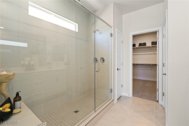 4180 E Brusca Way, Pahrump, NV 89061 - bathroom with a shower stall, tile patterned floors, a spacious closet, and baseboards