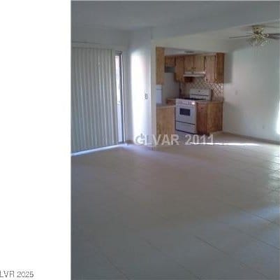 1405 Vegas Valley Dr Unit 378, Las Vegas, NV 89169 - unfurnished living room featuring a ceiling fan and light tile patterned floors