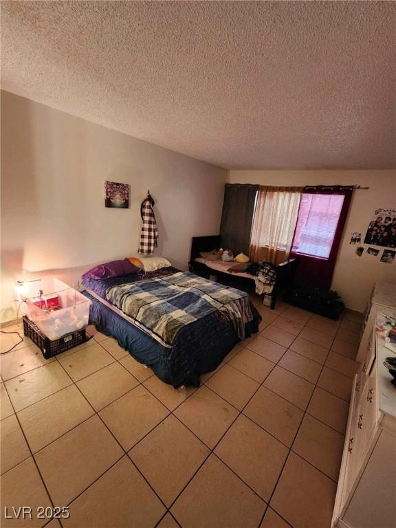1405 Vegas Valley Dr Unit 378, Las Vegas, NV 89169 - bedroom featuring light tile patterned floors and a textured ceiling