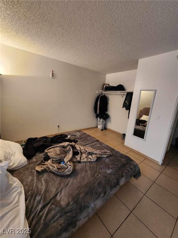 1405 Vegas Valley Dr Unit 378, Las Vegas, NV 89169 - bedroom with light tile patterned floors, a textured ceiling, and a closet